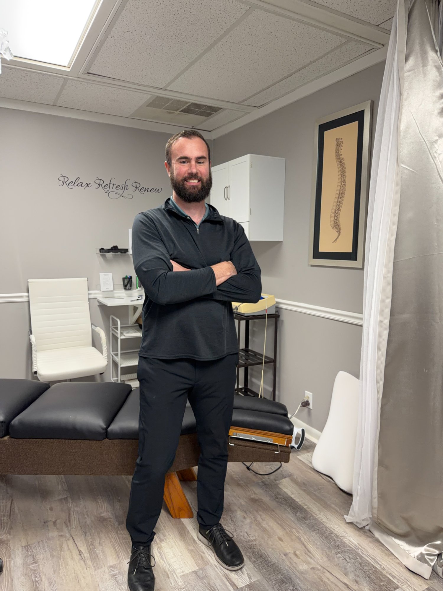 Dr. Branden Race, DC, in the treatment room at Injury & Performance Chiropractic in Ponte Vedra Beach, Florida